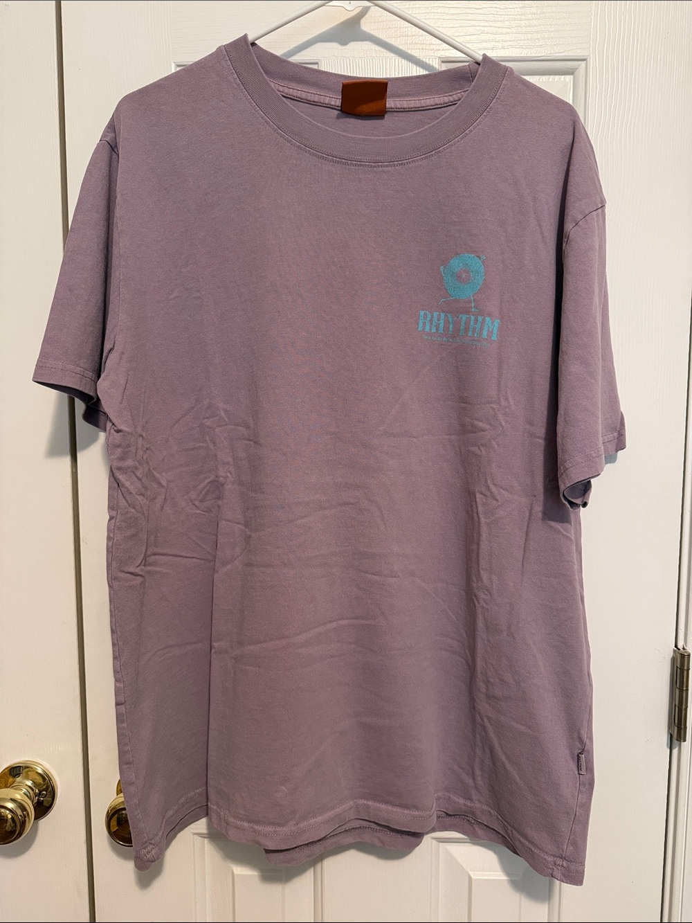 Rhythm. Men's Lavender Short Sleeve Tee with Teal Chest Logo